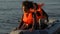 Multiethnic women getting ashore on lifeboat, refugees escaping from country