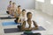 Multiethnic women practice yoga meditate in sports center