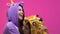 Multiethnic women in unicorn and giraffe pajamas hugging and laughing, fun