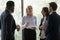 Multiethnic young employees listen guidance of middle-aged female boss