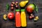 Multifruit drink in plastic bottle on wooden background top view