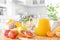 Multifruit juice and fresh fruit on table on kitchen background