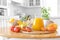 Multifruit juice and fresh fruit on table on kitchen background