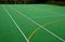 Multifunctional outdoor playground for ball games at school. green artificial turf from a plastic carpet with lines. basketball ho