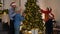 Multigeneration family decorating Christmas tree