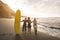 Multigeneration friends going to surf on tropical beach - Family people having fun doing extreme sport - Joyful elderly and