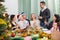 Multigenerational cheerful family sitting at festive table