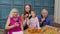Multigenerational family having lunch party, eating pizza food, laughing, raising toast at home