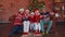 Multigenerational family taking selfie photo on timer mobile phone at decorated Christmas home