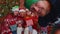 Multigenerational family taking selfie photo on timer mobile phone at decorated Christmas home