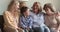 Multigenerational family women talking sit on sofa at home