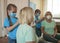 Multigenerational relations, girl and granny wearing respirators having fun and making hairdo together