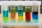 Multilayer systems of colored liquid insoluble substances in test tubes.