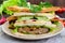 Multilayered sandwiches with a juicy cutlet, cheese, radish, cucumber, lettuce, arugula