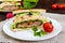 Multilayered sandwiches with a juicy cutlet, cheese, radish, cucumber, lettuce, arugula