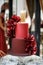 Multilevel wedding cake decorated with red flowers