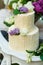 The multilevel wedding cake with lilac on the table