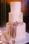 Multilevel wedding cake tied with a pink bow