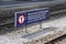 Multilingual warning sign at the railroad station platform