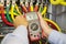 Multimeter in hands of electrician in power high voltage three phase circuit box close-up. Engineer hands with tester measured.