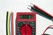 Multimeter with text on display 1000 V and heat shrink insulation on white background