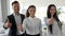 Multinational business peoples Show hand gesture like in white and spacious office, office people with thumbs up at