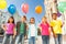 Multinational children with balloons standing