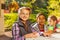 Multinational children sit together at table