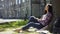 Multinational young woman sitting calmly under tree with closed eyes, relaxation