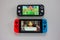 A multiplayer Nintendo Switch and single player Nintendo Switch Lite gaming consoles side by side