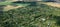 Multiple allotment gardens with little arbors, greenhouses, trees and bushes, aerial view