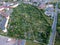 Multiple allotment gardens with little arbors, greenhouses, trees and bushes, aerial view