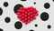 Multiple balloons forming a heart in the center, white background black spots
