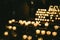 Multiple candles light in a row in Strasbourg Notre-Dame cathedral