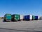 Multiple cargo trucks parked in large wide parking on a sunny summer day