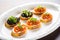 multiple caviar bruschetta servings on a classic white plate