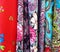 Multiple colorful pieces of traditional simple Polish flowery fabric with floral themes patterns. Multi colored cloth hanging