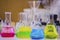 Multiple colorful solution in conical flask on a bench in a chemistry lab with blur background organic chemistry experiment