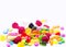 Multiple coloured sugar candy in white background with space for text