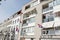 Multiple dutch flags on a facade of apartments