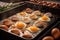 multiple eggs frying in a large griddle pan