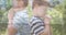 Multiple exposure of caucasian elementary boys praying against trees and bible on table