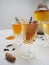 Multiple glasses with a variety of flavored kombucha tea such as cinnamon, citrus, turmeric and rosemary