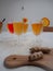 Multiple glasses with a variety of flavored kombucha tea and a wooden cutting board with turmeric