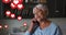 Multiple heart icons floating against african american senior woman talking on smartphone