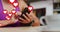 Multiple heart icons floating against mid section of caucasian woman using smartphone