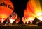 Multiple hot air balloons night glow