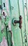Multiple keyholes and a rusty vintage door handle closeup