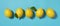 Multiple lemons placed on a blue background