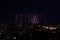 Multiple lightning strikes over a big city by night